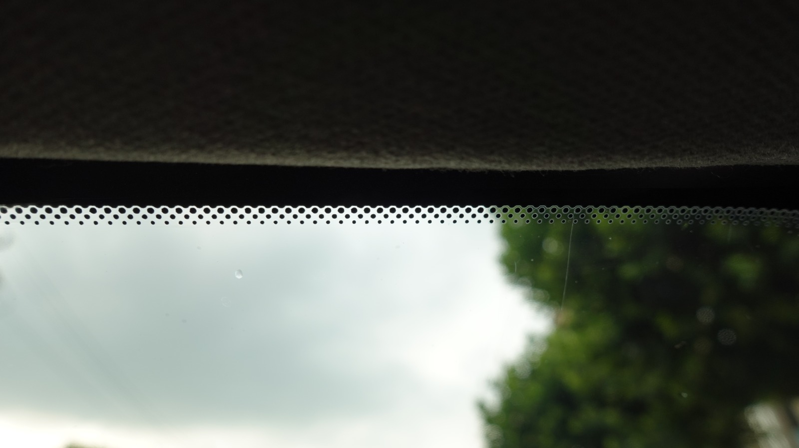 Here’s What Those Little Black Dots On Car Windows And Windshields Are For